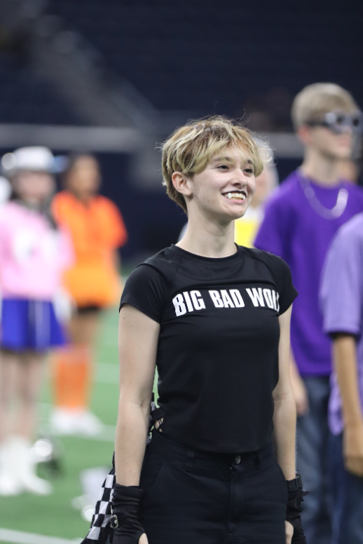 Senior Teagan Lesnau stands with the band in costume. The band prepares to start their special Halloween performance to Michael Jackson’s “Thriller” for half time.